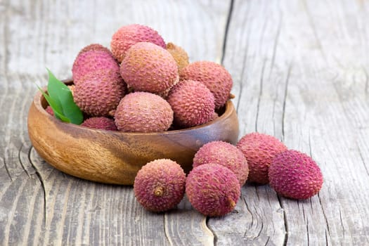 fresh lychees in a bowl  on wooden background