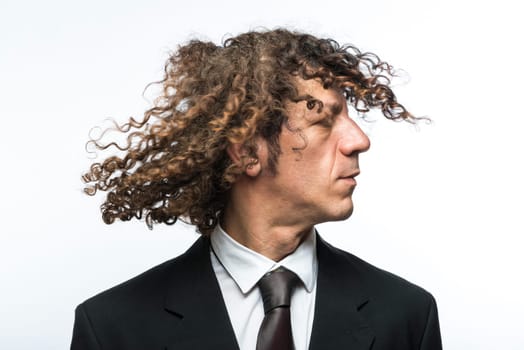Curly haired businessman moving head with hair in the air