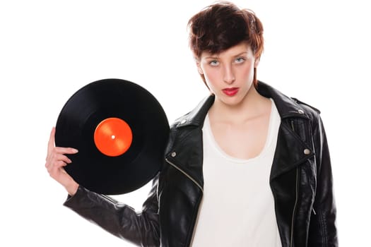 Cool woman with leather jacket holds record against white background