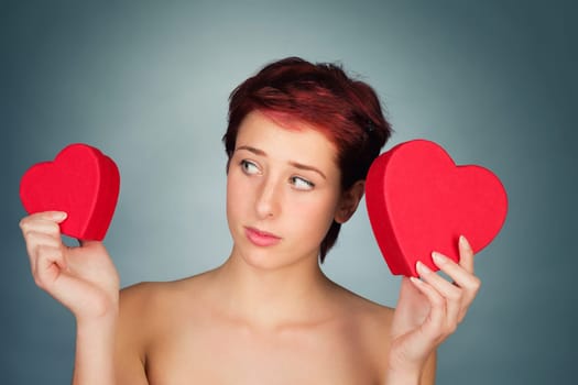 Young undecided woman chooses between two red hearts