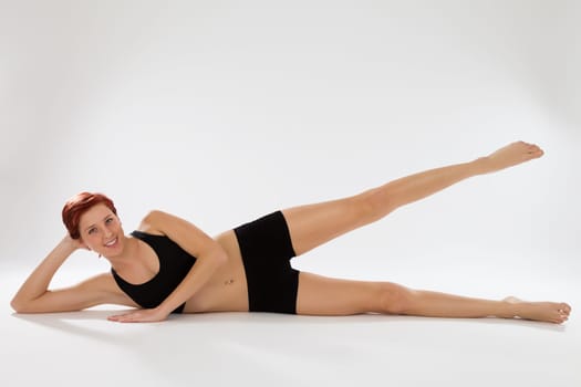 Young fitness woman trains her legs