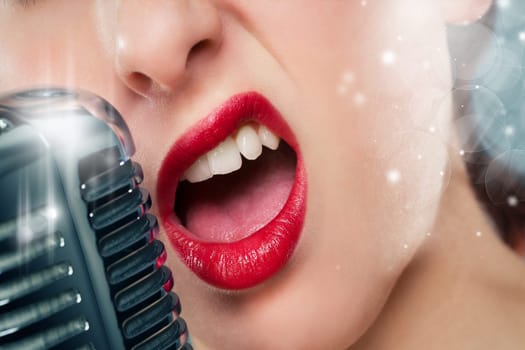 Mouth of a beautiful woman with red lipstick singing into a microphone