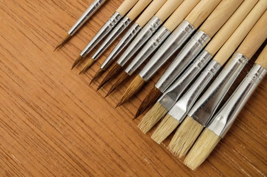 New Wooden Different Paintbrush Set Texture over a Colored Background