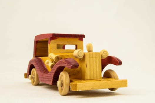 Wooden Toy Red and Yellow Car on a white Backgraund