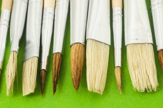 New Wooden Different Paintbrush Set Texture over a Colored Background