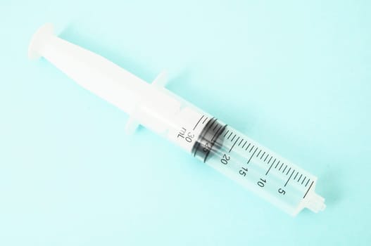 Big Black and White Syringe on a Colored Background