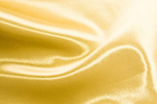 Golden satin or silk background with beautiful waves