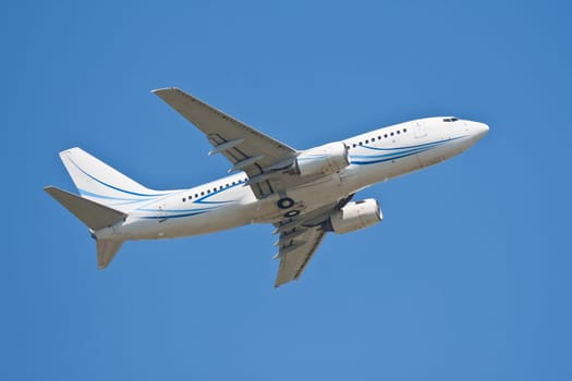 Beautiful white passenger airplane in blue sky