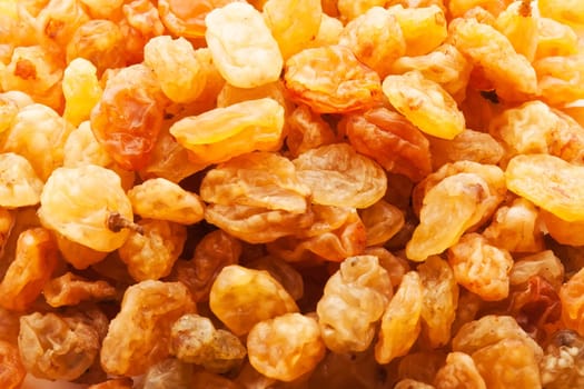 Heap of raisins - golden dried grapes background
