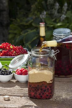Make your own blackcurrant liqueur,Step 4,add brandy to the glass with the fruits and cane sugar