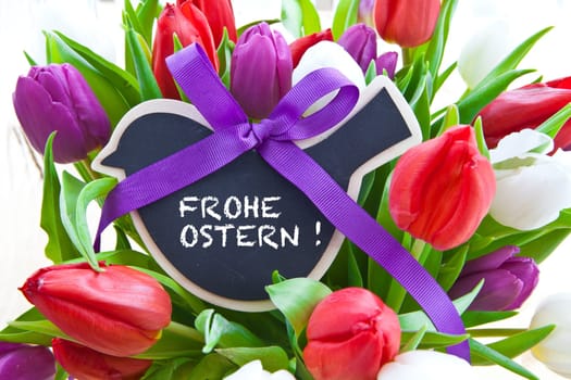 Fresh colorful tulips with small table in the shape of a bird