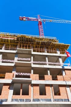 Construction of modern apartment building under blue sky