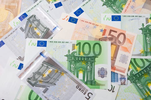 Many euro banknotes making european currency background