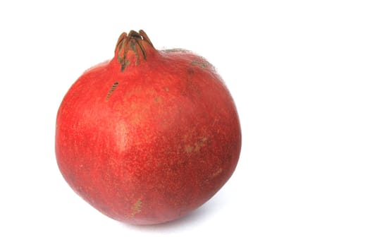 Ripe pomegranate (Punica granatum) exposed against a white background