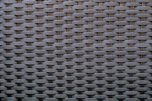 Full frame image of colored woven wicker creating optical illusion.