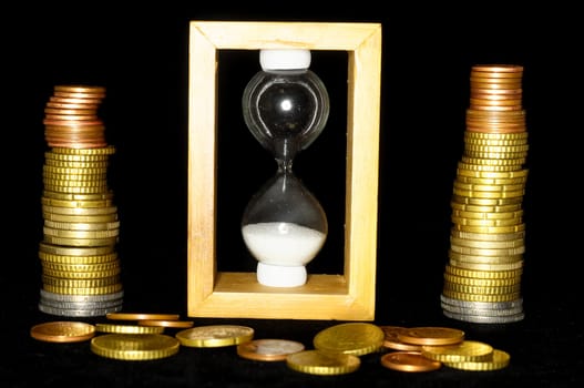 Buisness Time Concept Hourglass and Money on a Black Background