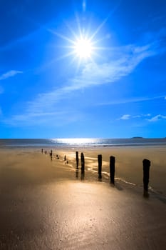 wave breakers at sunset on a golden beach in youghal county cork ireland