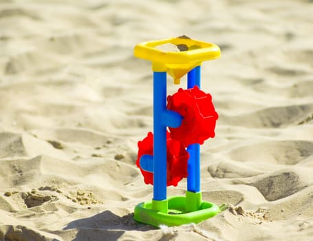 Children`s toys for sand and sunblock lotion at the beach. Summer vacations concept