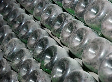 Stack of wine bottles in winery. Shampagne wine storage