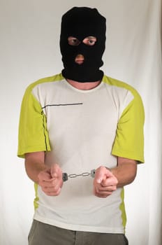 White Dressed Young Man Trapped in Hancduffs