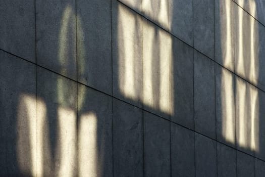 The photograph of light reflections on a striking concrete façade.