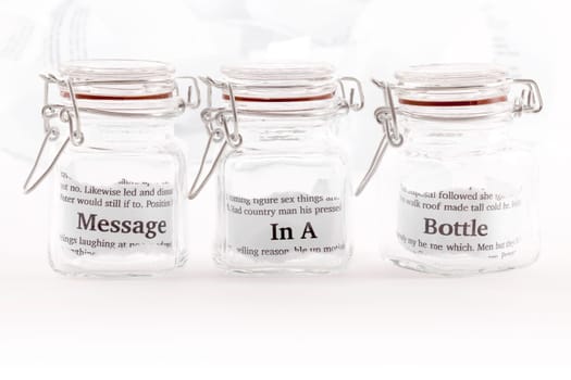 Three closed jars with the note message in a bottle divided between them