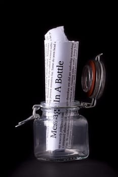 Message in a bottle letter in portrait styl, inside a glass jar with a black background