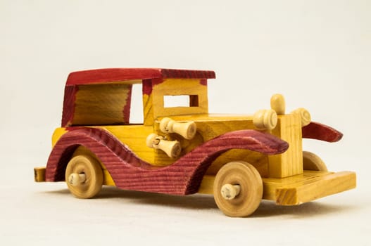 Wooden Toy Red and Yellow Car on a white Backgraund