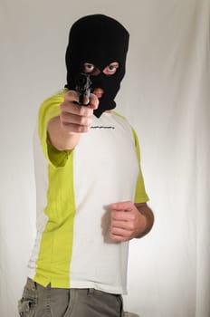White Dressed Young Man Holding a Pistol Gun