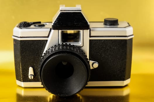 Classic 35mm Plastic Toy Photo Camera on a Colored Background