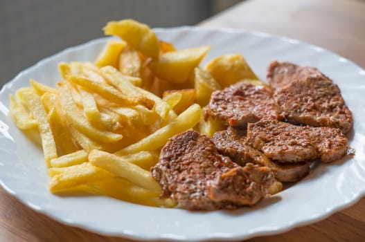 Beef steak with fries on a plate
