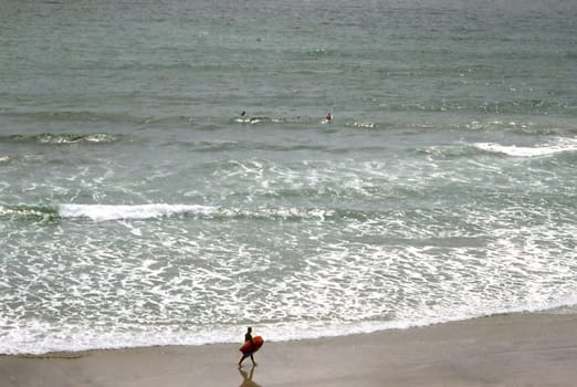 Surfer on beach in San Diego, California