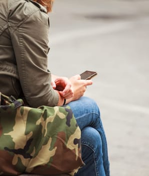 Girl writing message with smart phone