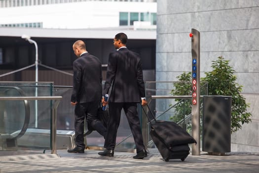 business men walking with travel bag