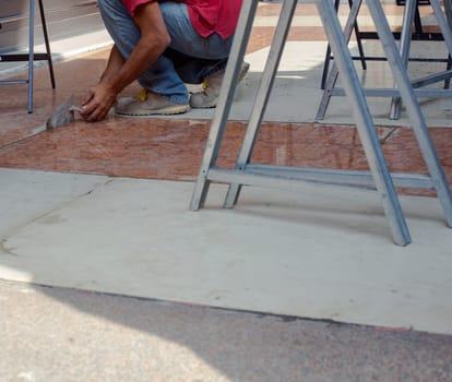Worker in action with trowel in the floor