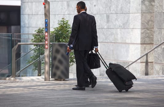 business men walking with travel bag
