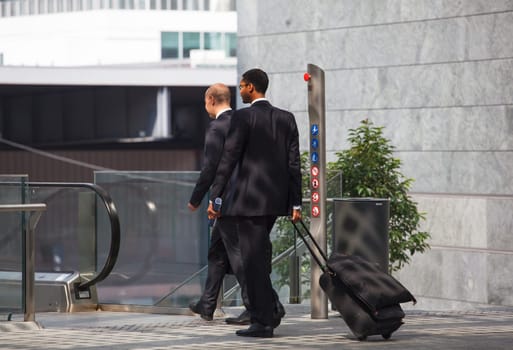business men walking with travel bag