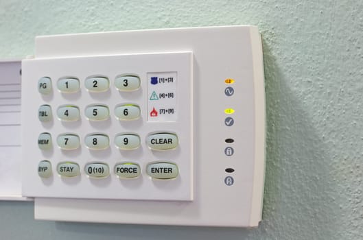 Security Appliances numeric keypad on the green wall