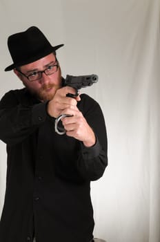 Black Dressed Young Man Holding a Pistol Gun