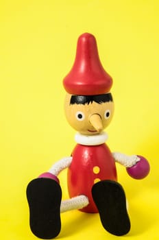 Pinocchio Toy Statue on a Colored Background