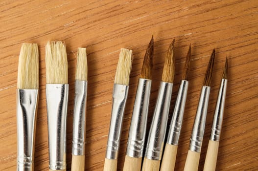 New Wooden Different Paintbrush Set Texture over a Colored Background