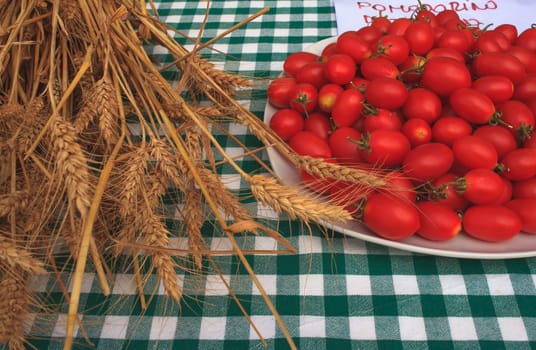 View of Wheat and tomatoes on tablecloth