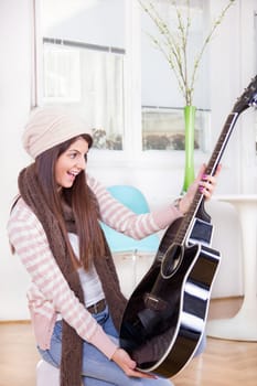 cute girl gets guitar as a present