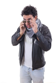 good looking adult man in a leather jacket talking over phone