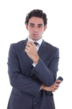 adult man in suit holding the remote while watching TV