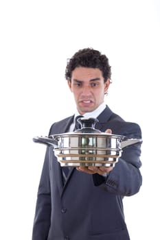 man in suit looking at pot for cooking with expression