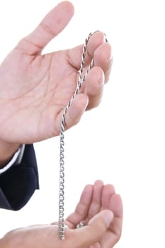 man hands holding silver necklace in studio isolated on white background