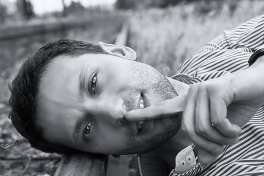 young male model lying on the rail