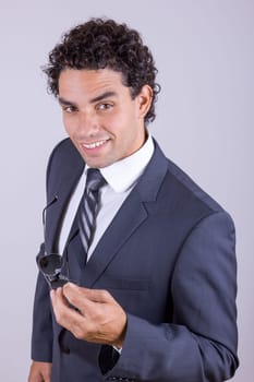 pleasant businessman in suit with sunglasess smiling