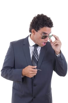 shocked young businessman with glasses holding keys